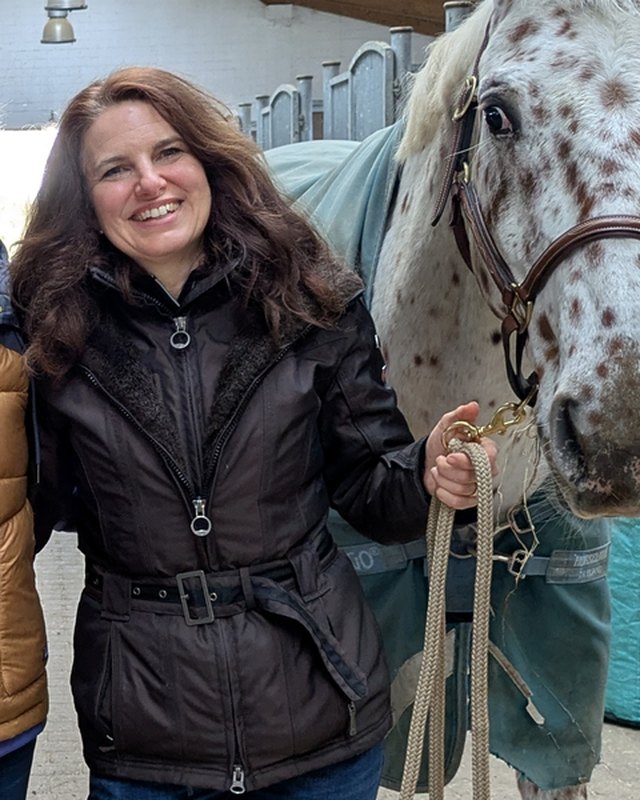 Tanja Geramb mit einem Pferd im Stall